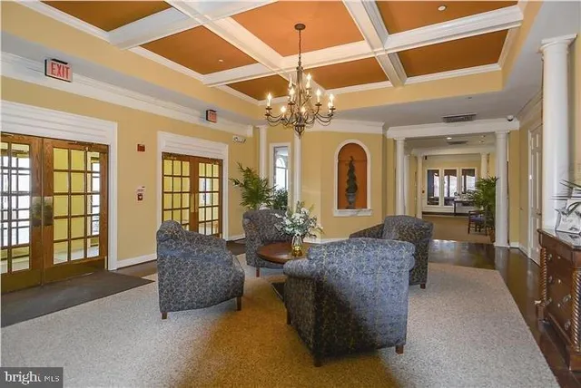 a living room with fireplace furniture and a chandelier