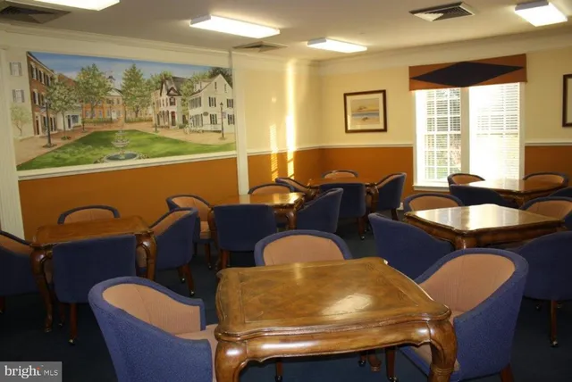 a dining room with furniture a window and wooden floor
