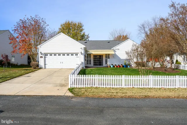 a view of a house with a yard next to a road