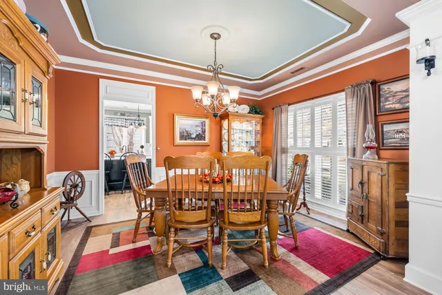 a view of a dining room with furniture wooden floor and a chandelier