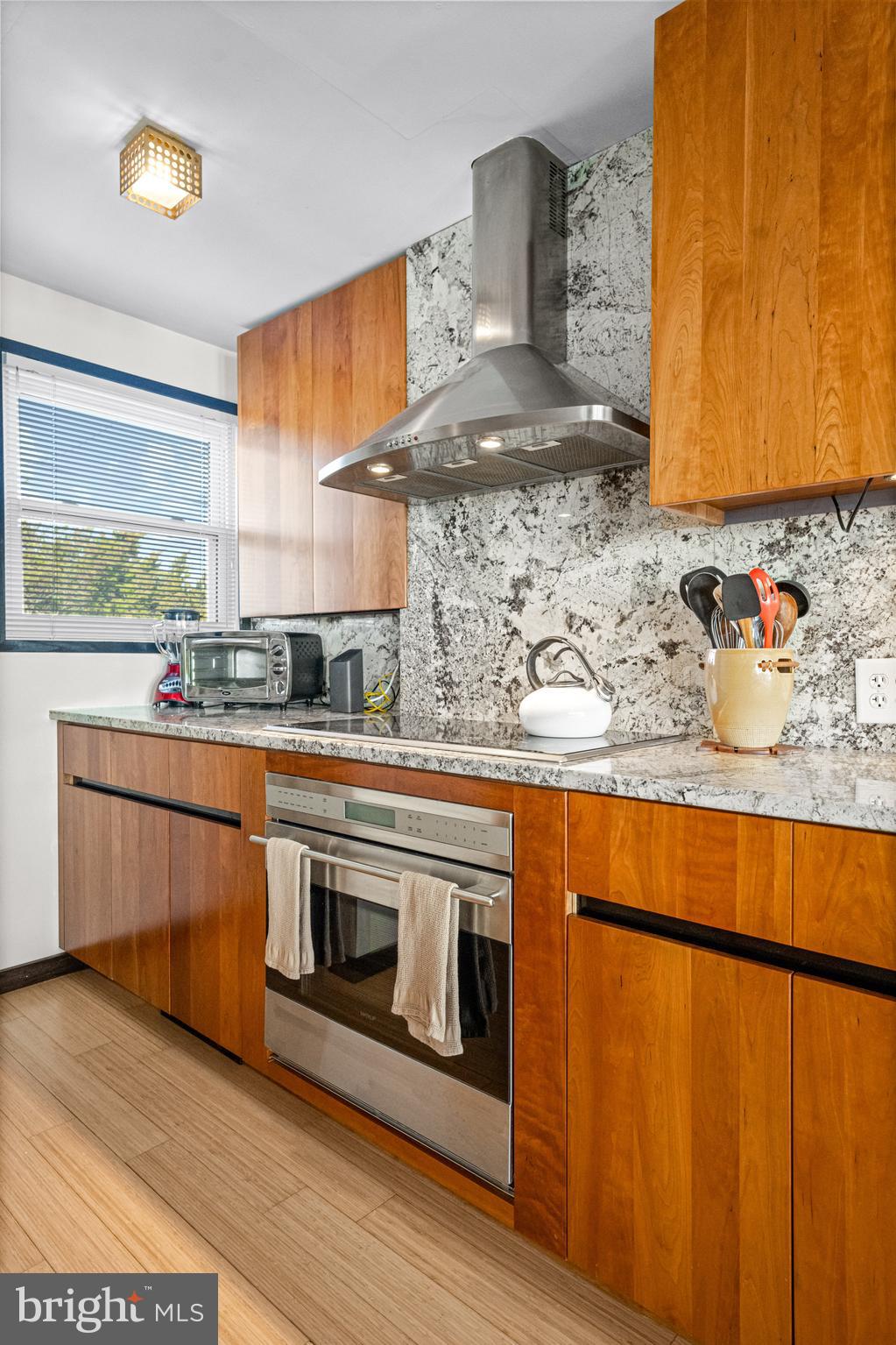 94 Delaware Avenue Fortescue, NJ 08321 - Photo 11 of 31 a kitchen with stainless steel appliances granite countertop a stove a sink and a microwave