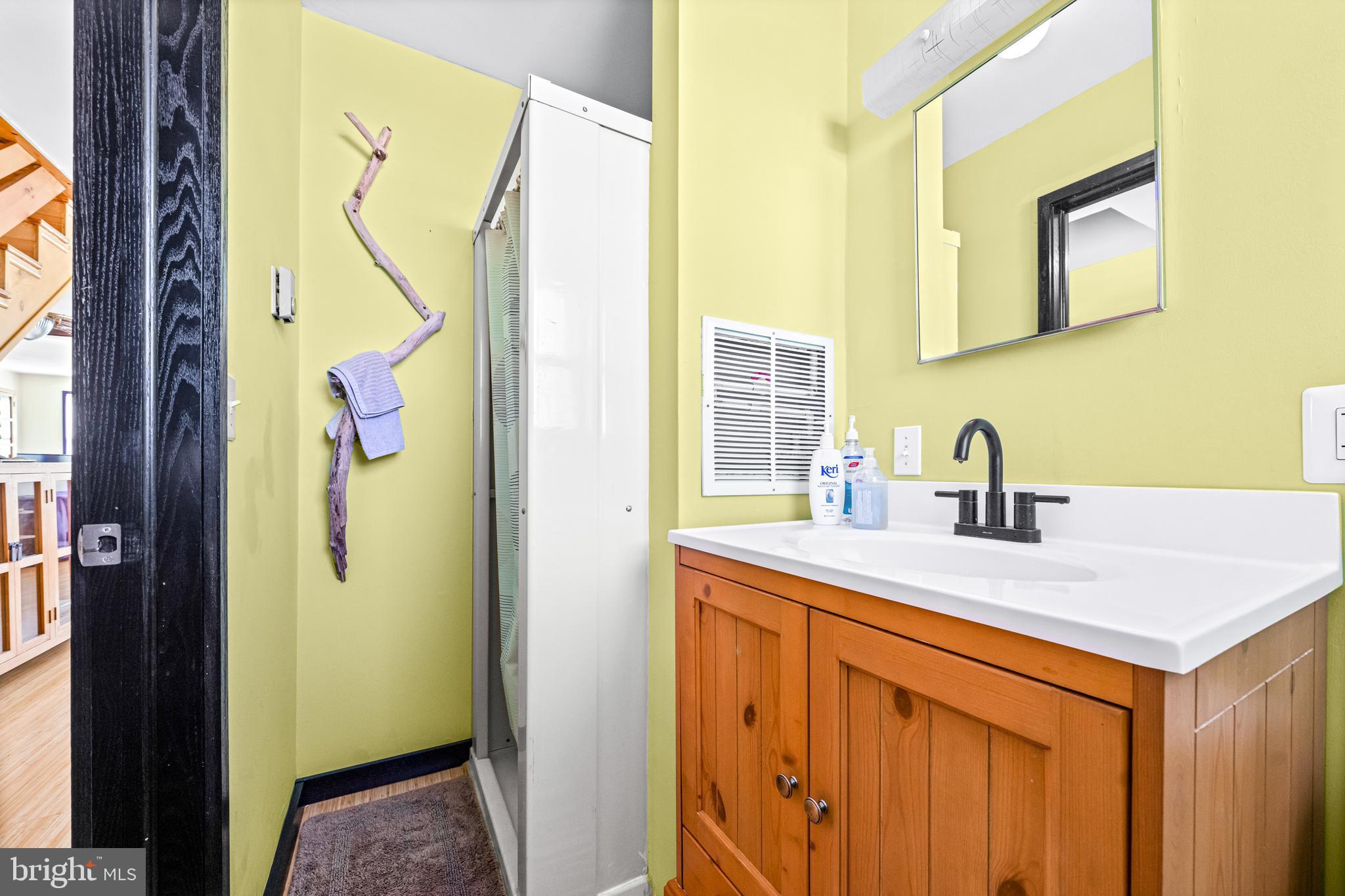 94 Delaware Avenue Fortescue, NJ 08321 - Photo 16 of 31 a bathroom with a sink and a mirror