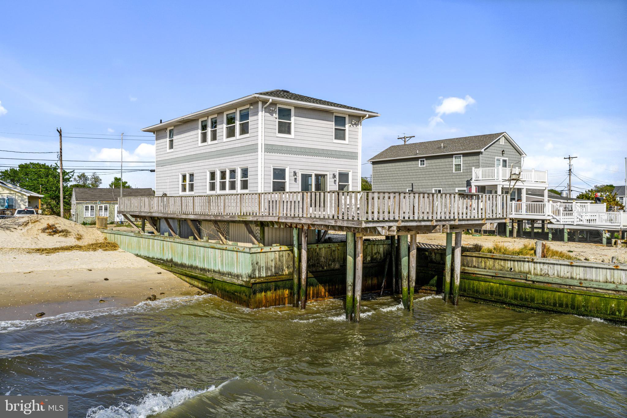 94 Delaware Avenue Fortescue, NJ 08321 - Photo 4 of 31 a large white building with a white swimming pool