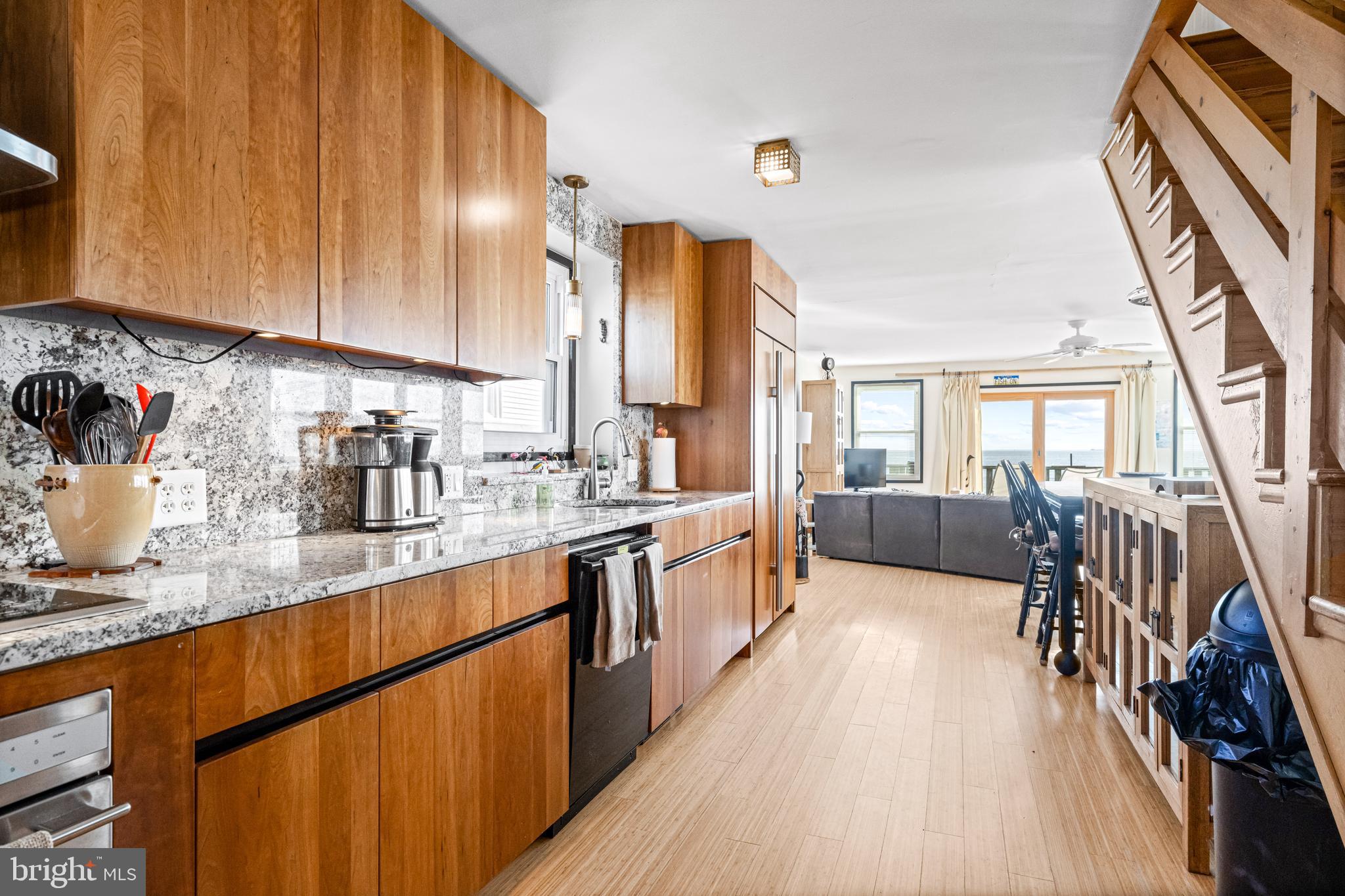 94 Delaware Avenue Fortescue, NJ 08321 - Photo 10 of 31 a large kitchen with stainless steel appliances granite countertop a lot of counter space and wooden floor