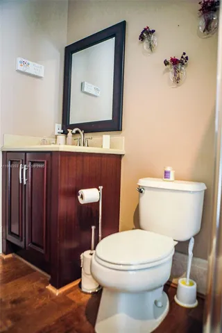 a bathroom with a toilet a sink and mirror