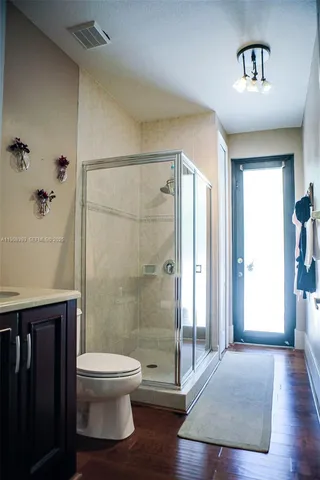 a bathroom with a toilet and a shower