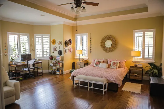 a bedroom with a bed and wooden floor