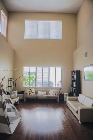 a living room with a couch next to a window