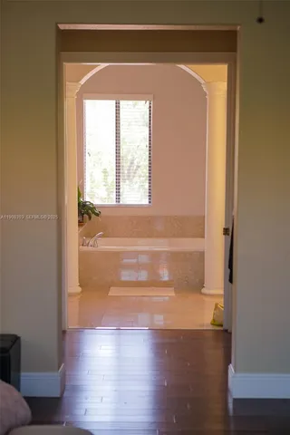 a view of walk in closet with wooden floor