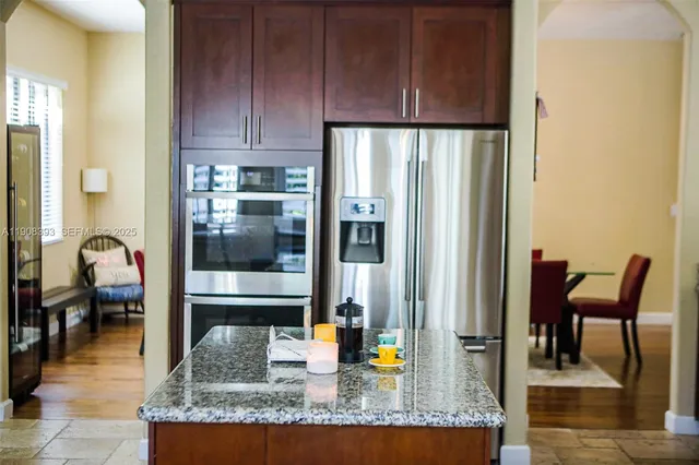 a kitchen with granite countertop a refrigerator and a stove