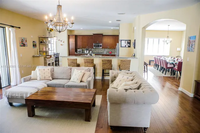 a living room with furniture and a chandelier