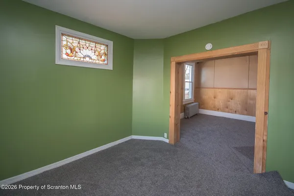 a room with a window and a chair