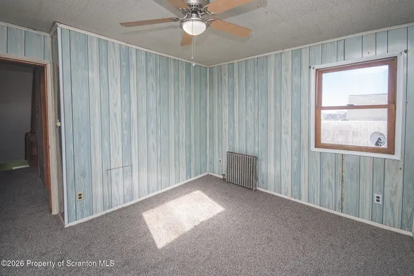 a view of an empty room with a ceiling fan