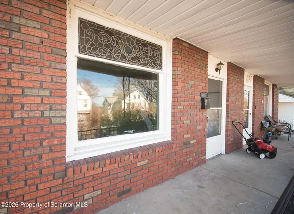 a view of front door of house with car parked