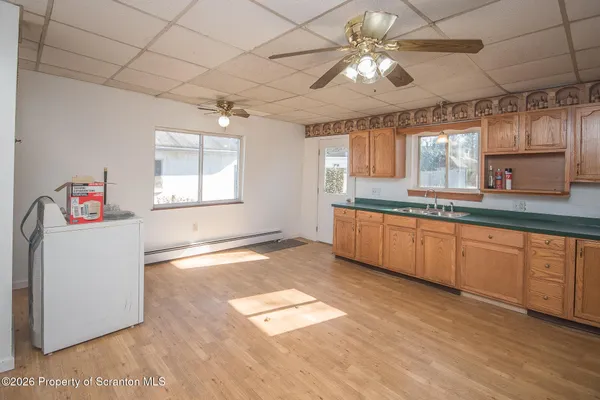 a kitchen with granite countertop a stove a sink and a refrigerator