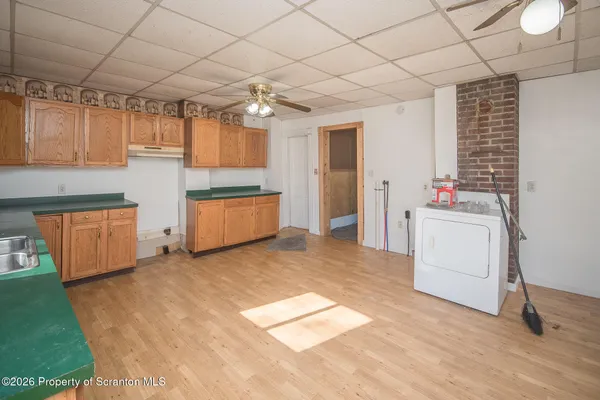 a kitchen with granite countertop a sink and a stove top oven