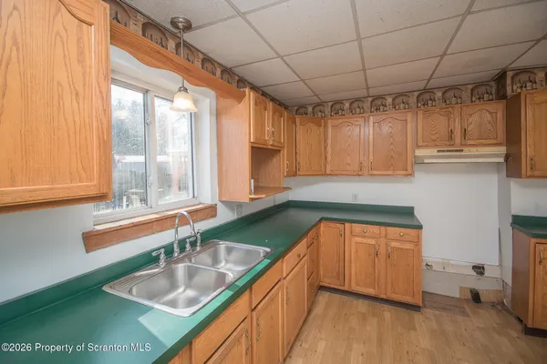 a kitchen with a sink and a large window