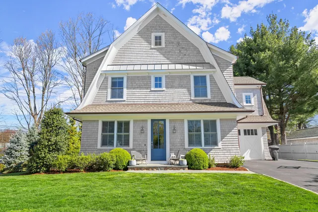 a front view of a house with garden and porch