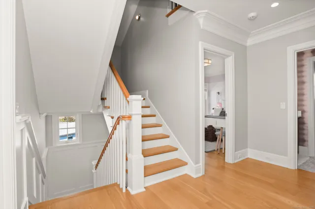 a view of entryway with wooden floor and stairs