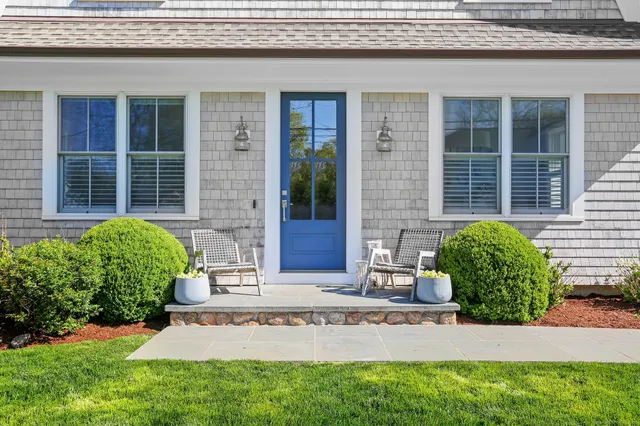 a front view of a house with a garden