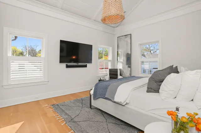 a bedroom with a bed and a flat screen tv