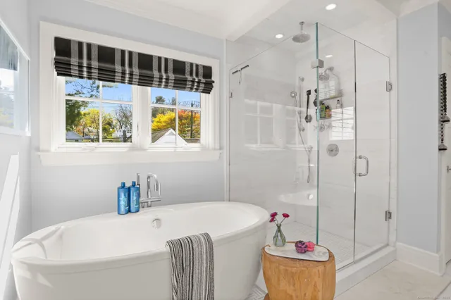 a bathroom with a tub a sink and a shower