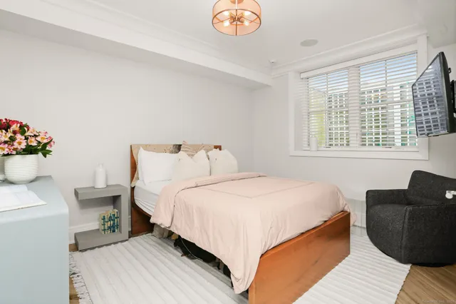 a bedroom with bed and a window