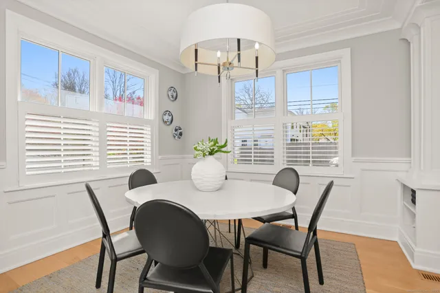 a view of a dining room with furniture window and wooden floor