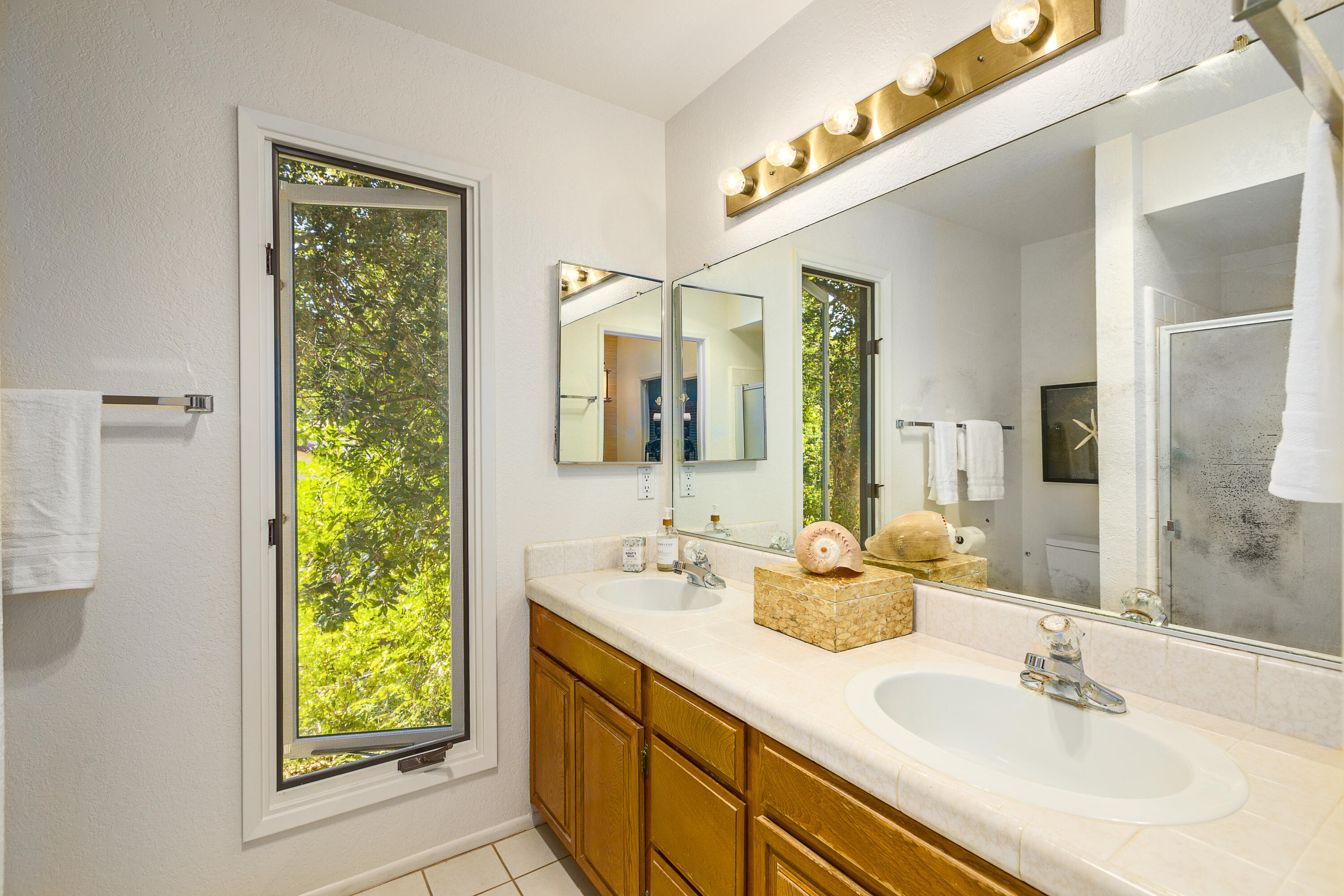 1532 Manitou Road Santa Barbara, CA 93105 - Photo 13 of 20 a bathroom with a double vanity sink and a mirror