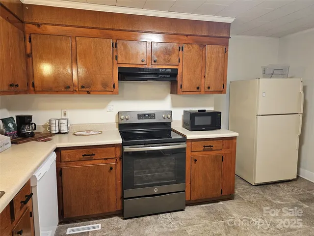 a kitchen with stainless steel appliances granite countertop a stove a refrigerator and a sink