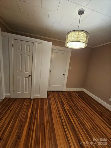 a view of a room with wooden floor gym equipment