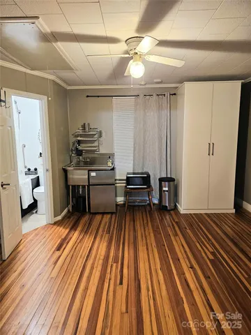 a spacious bedroom with a bed and a chandelier