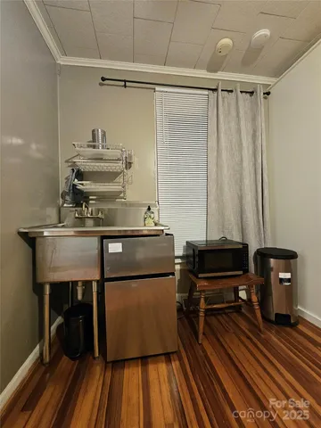 a room with a chair and wooden floor