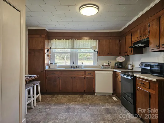 a kitchen with stainless steel appliances granite countertop a stove a sink dishwasher and a refrigerator