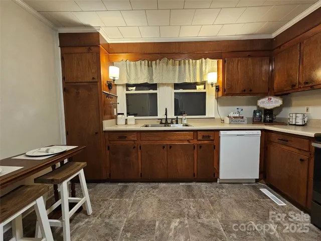 a kitchen with a sink appliances and cabinets