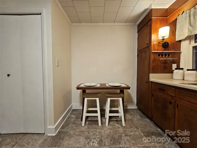 a yellow room with a table and chairs