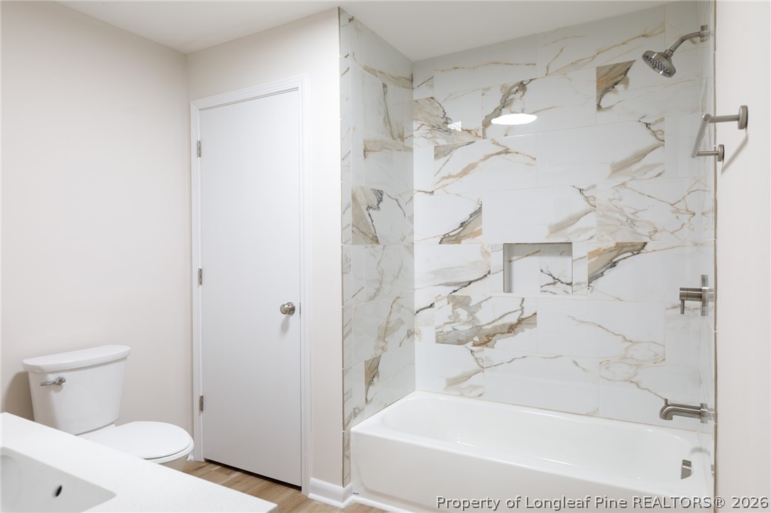 201 Scarborough Street Spring Lake, NC 28390 - Photo 13 of 26 a bathroom with a bathtub and a shower