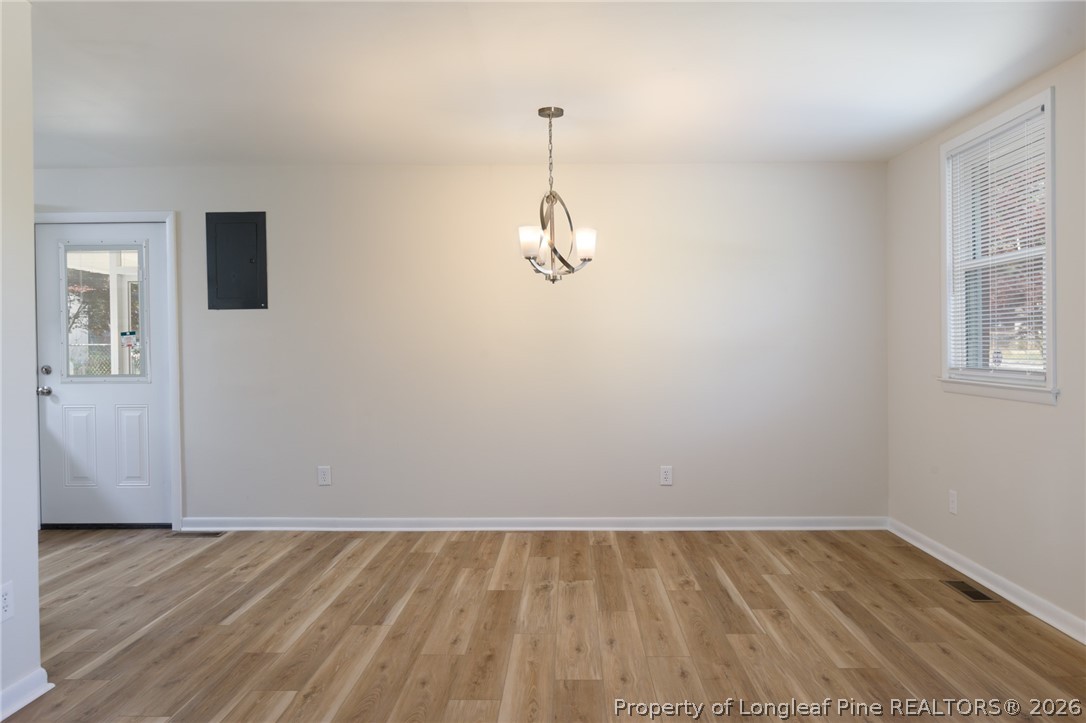 201 Scarborough Street Spring Lake, NC 28390 - Photo 6 of 26 a view of a room with wooden floor and windows