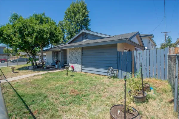 a backyard of a house with yard and outdoor seating