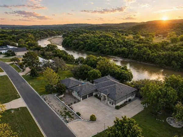 an aerial view of residential house with outdoor space and river