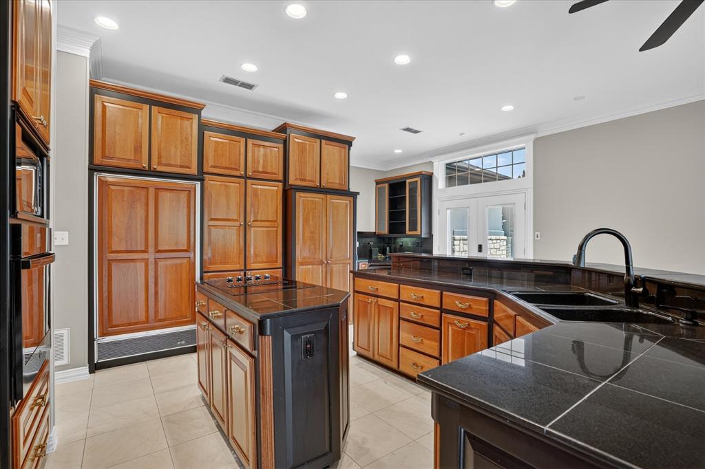 9704 Ravenswood Road Granbury, TX 76049 - Photo 13 of 40 a kitchen with stainless steel appliances granite countertop a stove a sink and a refrigerator
