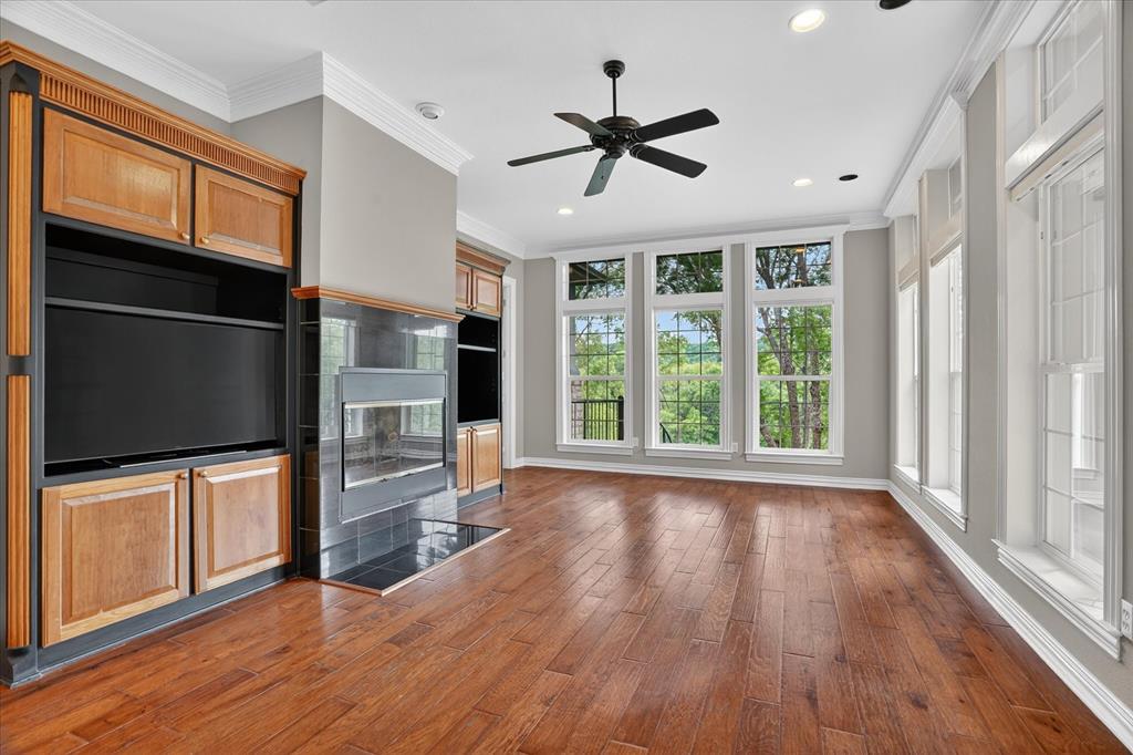 9704 Ravenswood Road Granbury, TX 76049 - Photo 15 of 40 a view of a livingroom with hardwood floor and a ceiling fan