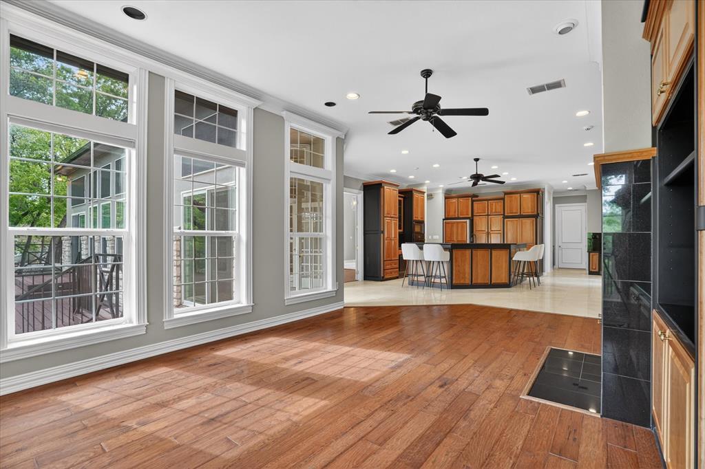 9704 Ravenswood Road Granbury, TX 76049 - Photo 16 of 40 a view of an empty room with a window and wooden floor
