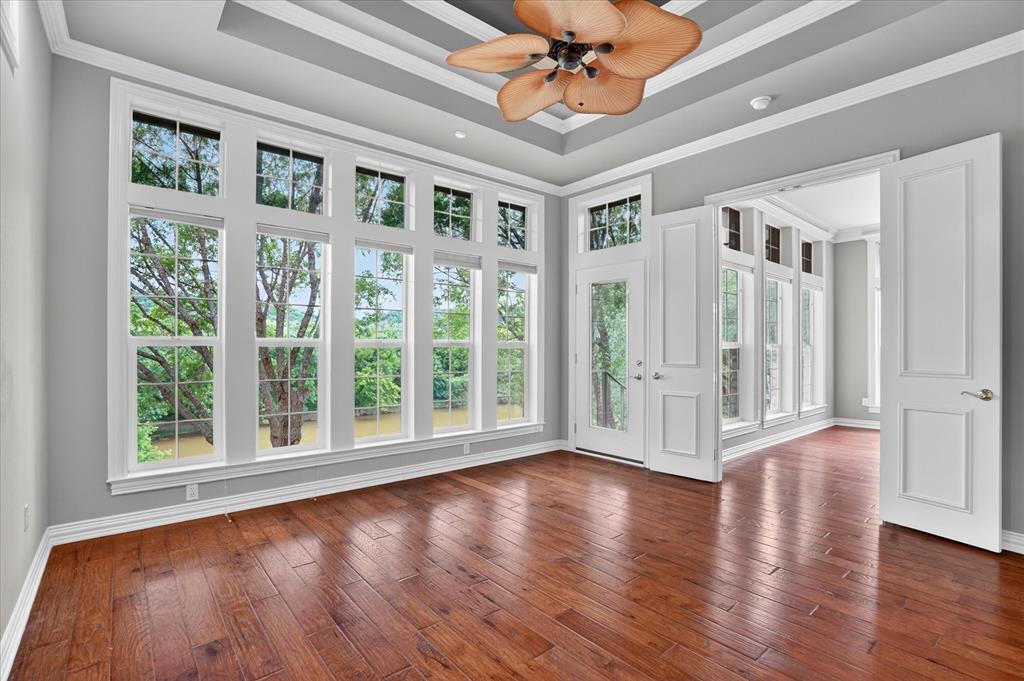 9704 Ravenswood Road Granbury, TX 76049 - Photo 18 of 40 a view of an empty room with wooden floor and a window
