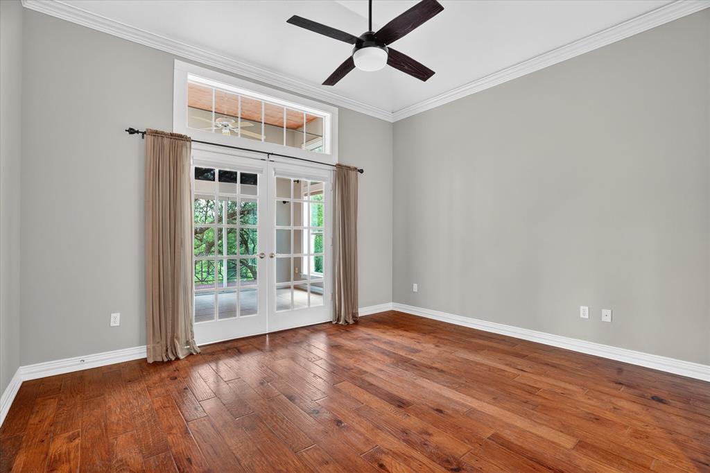 9704 Ravenswood Road Granbury, TX 76049 - Photo 23 of 40 a view of an empty room with a window and wooden floor