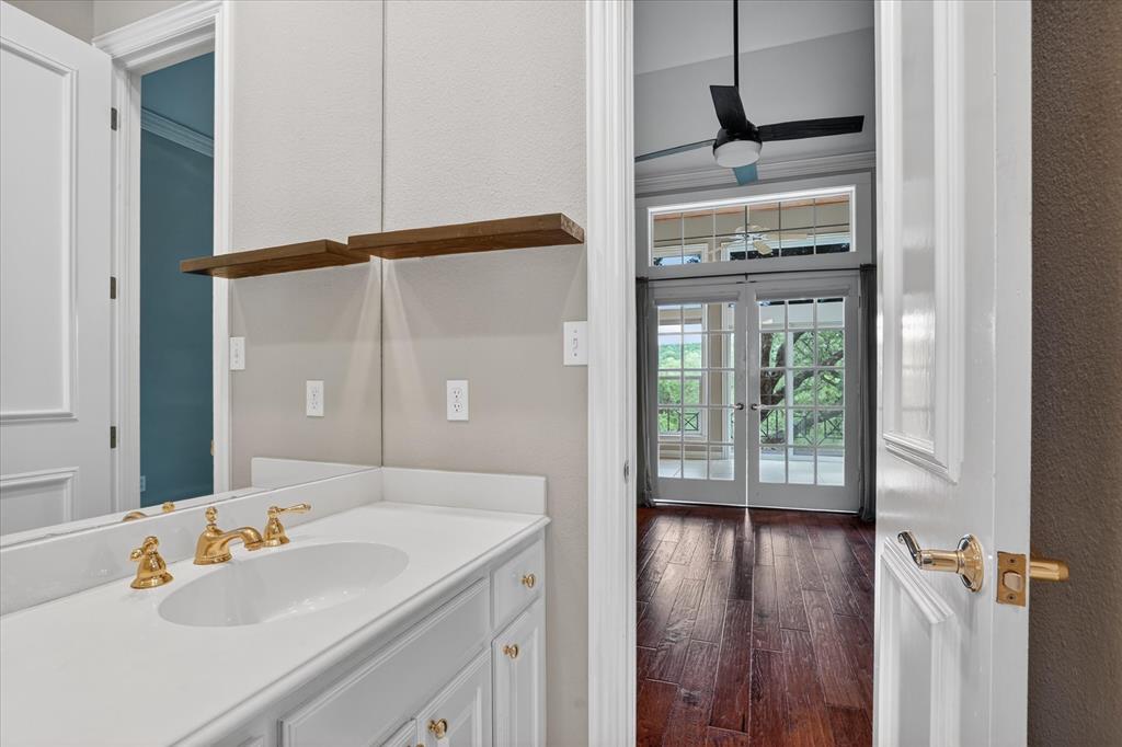 9704 Ravenswood Road Granbury, TX 76049 - Photo 24 of 40 a bathroom with a sink a mirror and a shower
