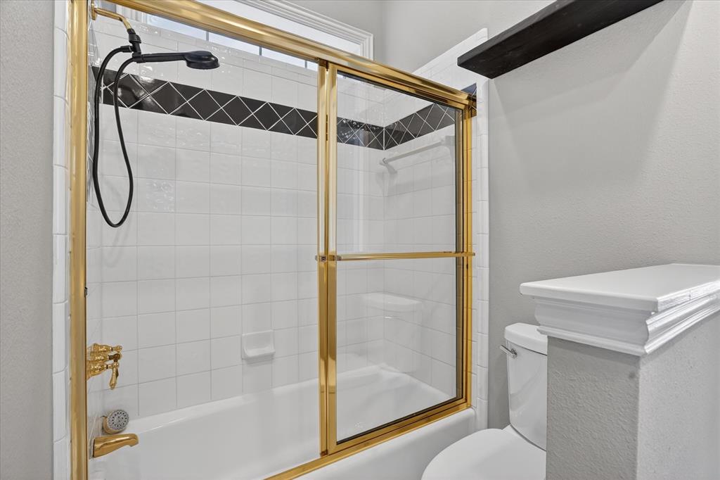 9704 Ravenswood Road Granbury, TX 76049 - Photo 25 of 40 a bathroom with a shower and a toilet