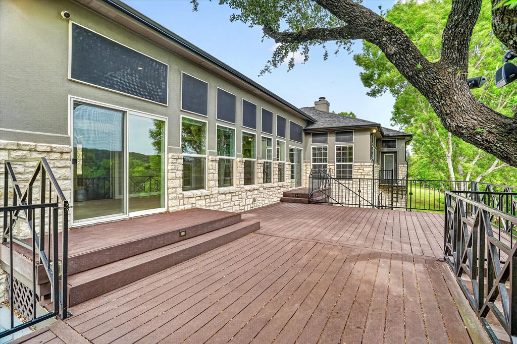 9704 Ravenswood Road Granbury, TX 76049 - Photo 27 of 40 a house with wooden floor and fence next to a yard