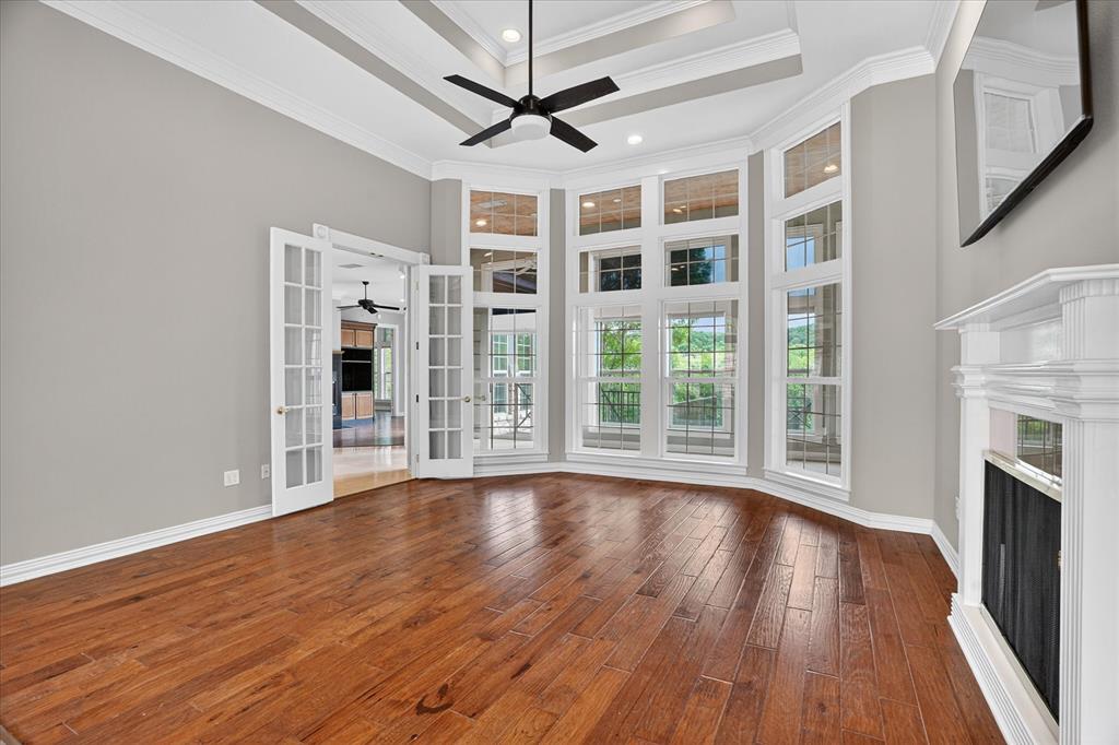 9704 Ravenswood Road Granbury, TX 76049 - Photo 3 of 40 a view of an empty room with wooden floor and a window