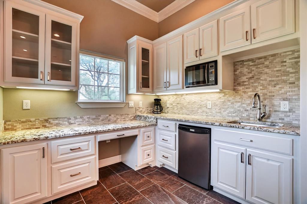 9704 Ravenswood Road Granbury, TX 76049 - Photo 32 of 40 a kitchen with stainless steel appliances granite countertop a sink stove and cabinets